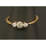 AN 18CT GOLD AND DIAMOND RING set with three small round-cut diamonds, totalling 0.20cts approx.,