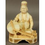 A ROYAL WORCESTER PORCELAIN 'INDIAN CRAFTSMAN' FIGURE, a seated figure before a spinning wheel,