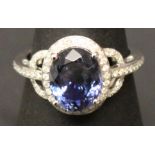 A 14KT WHITE GOLD AND DIAMOND RING set with an oval cut tanzanite approx. 3.50ct, diamonds approx