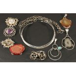 A COLLECTION OF HAND-CRAFTED WHITE METAL JEWELLERY comprising five brooches and three pendants, each