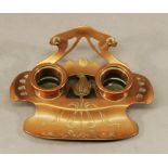 AN ART NOUVEAU STYLE COPPER INK STAND of shaped and pierced form with stylised floral decoration,