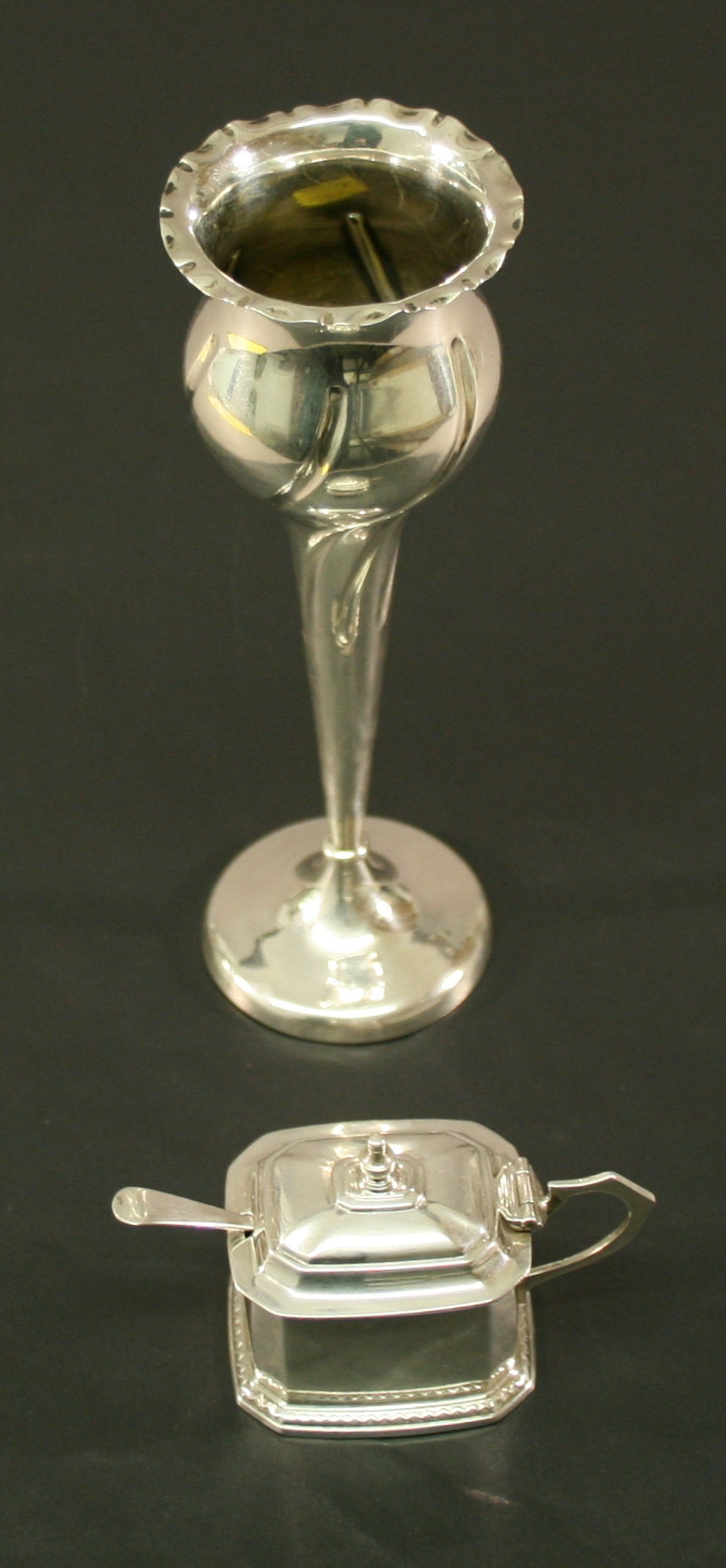 AN EDWARDIAN ART NOUVEAU SILVER TULIP VASE of spirally fluted organic form with tapering stem and