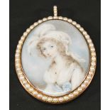 A 19TH CENTURY PEARL SET PORTRAIT MINIATURE MOURNING PENDANT of oval form, watercolours on ivory