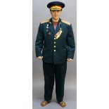 A RUSSIAN ARMY UNIFORM compromising tunic, trousers, belt and cap, the tunic with assorted insignia,