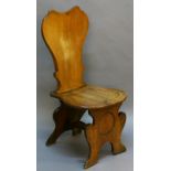 A GEORGIAN FRUITWOOD 'SGABELLO' HALL CHAIR of typical form with shaped back, dished seat and front