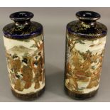 PAIR OF JAPANESE SATSUMA VASES of cylindrical form with short everted necks, decorated with panels