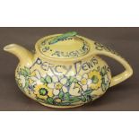 A "GLASGOW GIRLS" CHINA  TEAPOT by Ann Macbeth 1942, of shaped ovoid form with sweeping handle and