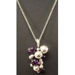 A GEORG JENSEN MIDNIGHT GRAPES PENDANT formed as a bunch of grapes with four graduating amethysts,