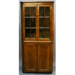 A 19TH CENTURY MAHOGANY DOUBLE CORNER CUPBOARD the upper stage with two doors, each with six