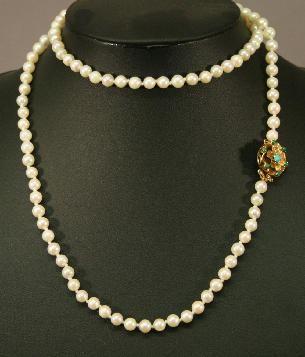 A 9CT GOLD AND PEARL NECKLACE with matching bracelet, the uniform string of pearls ending with a