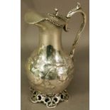 A 19TH CENTURY WHITE METAL HOT WATER JUG of baluster form with hinged cover and scroll handle with