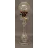 A 19TH CENTURY CUT-GLASS PEDESTAL OIL LAMP with associated etched and cranberry tinted globular