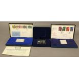 TWO DANBURY MINT SILVER COMMEMORATIVE STAMP EDITIONS, the first a Silver Jubilee edition with four