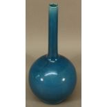 A BURMANTOFTS POTTERY BOTTLE VASE the slender neck and globular body with indigo glaze, impressed