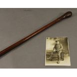 A FIRST WORLD WAR ERA LEATHER SWAGGER STICK AND PHOTOGRAPH, the swagger stick leather covered. 91cm: