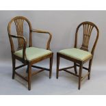 A SET OF SIX GEORGIAN ELM DINING CHAIRS comprising five single chairs and one carver, each with