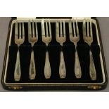 A CASED SET OF SIX SILVER DESSERT FORKS of typical form, within a fitted leather covered case
