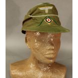 A REPRODUCTION AFRIKA KORPS CAP having insignia to front, lined with red fabric. CONDITION: Good,