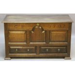 AN 18TH CENTURY OAK MULE CHEST having a hinged, moulded rectangular top, frieze craved with initials
