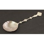 A LATE VICTORIAN SILVER FRUIT SERVING SPOON by Mappin  & Webb, the scalloped bowl and ornate knopped