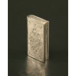 A MID-20TH CENTURY DUTCH WHITE METAL VESTA CASE in the form of a book with moulded and chased