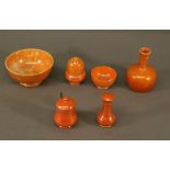 A GROUP OF MOORCROFT POTTERY ORANGE LUSTRE WARES comprising two bowls, vase and three