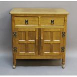 AN ALAN GRAINGER 'ACORN INDUSTRIES' OAK MUSIC CABINET having an adzed rectangular top, two