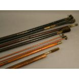 A COLLECTION OF GUN CLEANING RODS consisting of brass mounted ebony, stained mahogany and metal rods