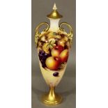 A ROYAL WORCESTER PORCELAIN HAND-DECORATED VASE of slender urn-form with finial topped cover and