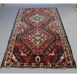 A HAMADAN RUG, the crimson field with two lozenge medallions within spandrels and borders. 278cm x