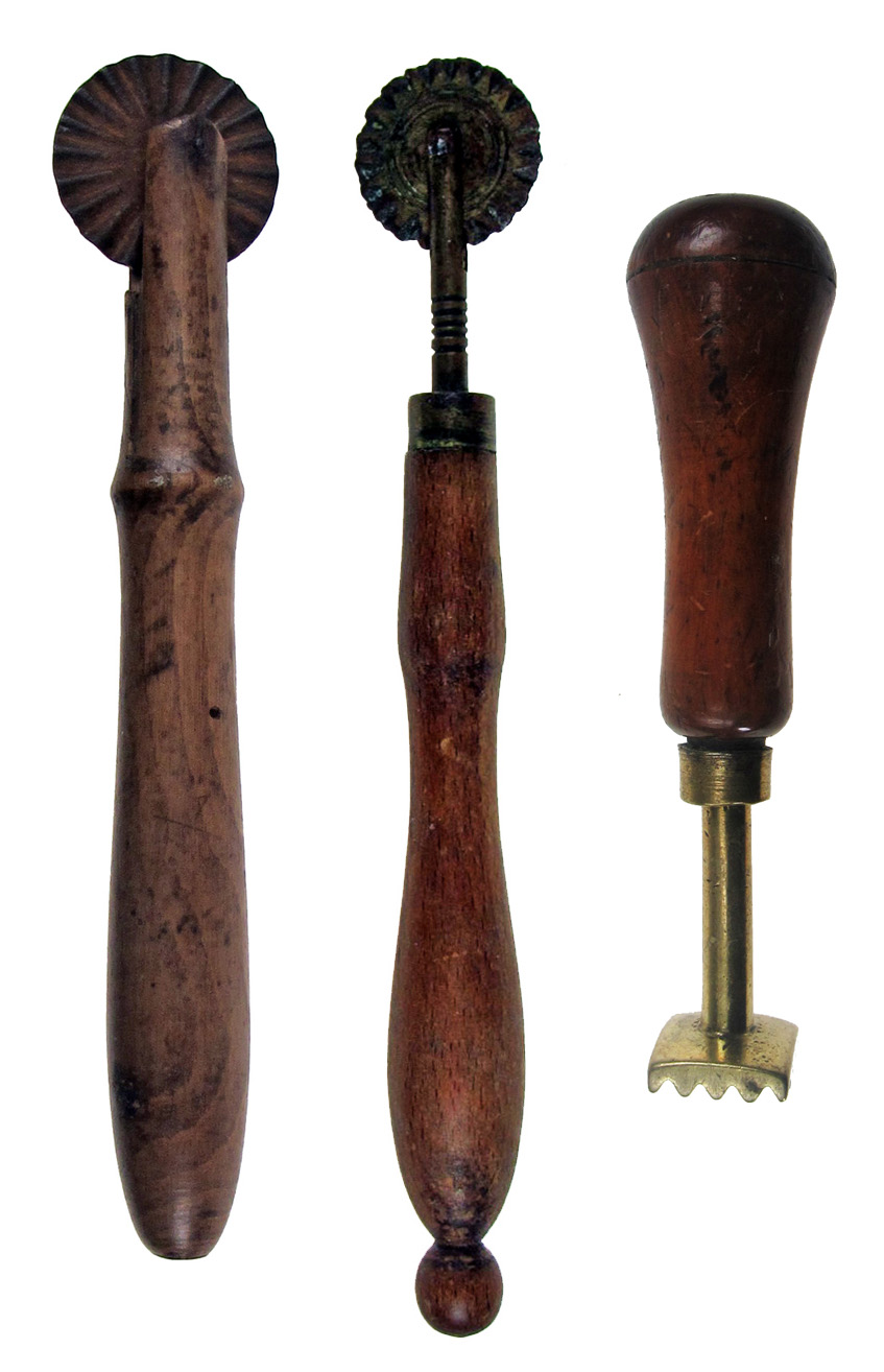 TWO 19TH CENTURY TREEN-HANDLED PASTRY JIGGERS, one with iron wheel, 15.5cm long, one with a brass