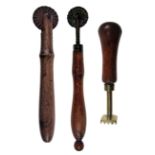 TWO 19TH CENTURY TREEN-HANDLED PASTRY JIGGERS, one with iron wheel, 15.5cm long, one with a brass