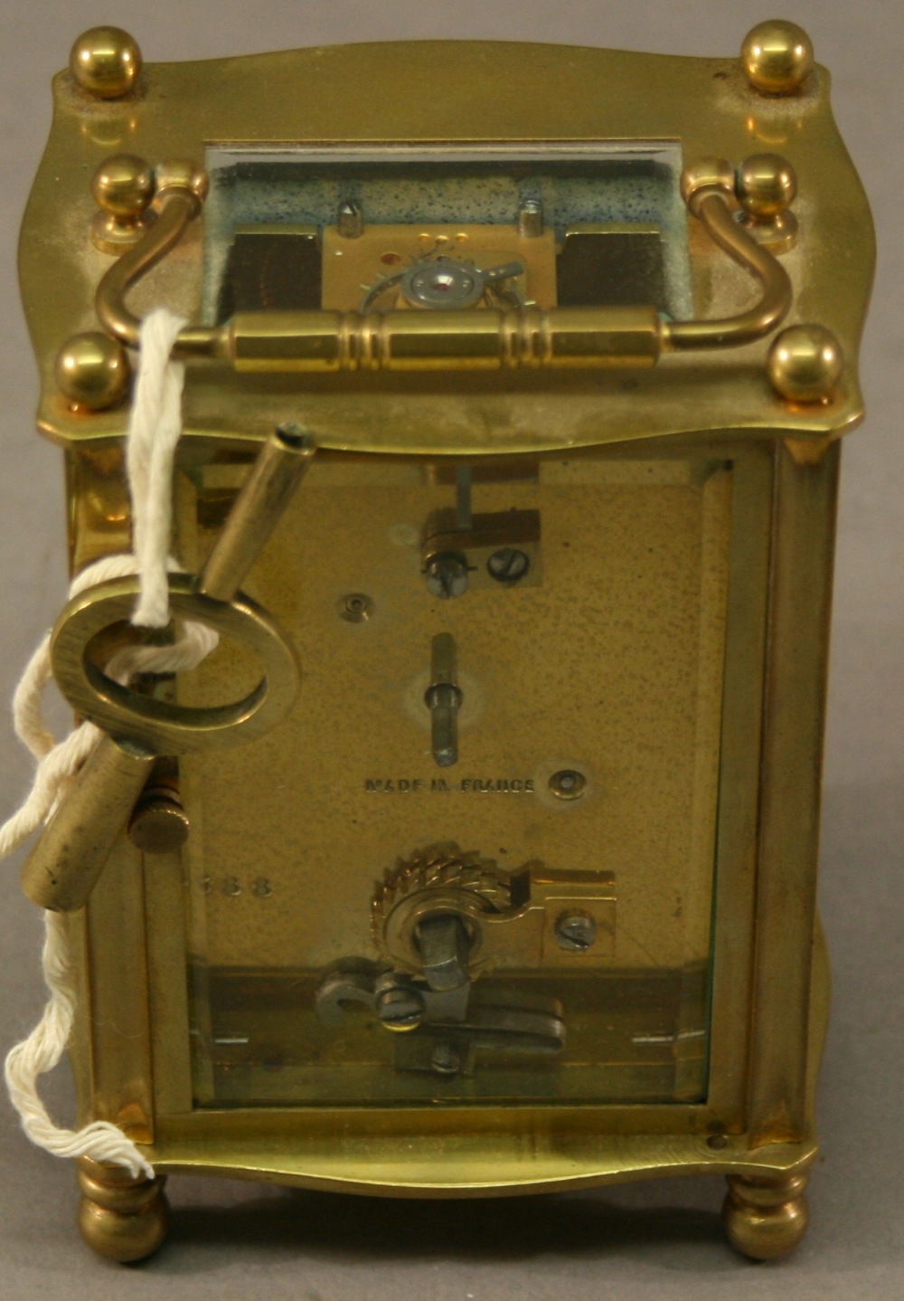 A FRENCH BRASS FIVE-GLASS CARRIAGE CLOCK of bowed form with shaped swing carrying handle, the - Image 2 of 2