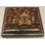 A 19TH CENTURY CHINESE LACQUERED GAMES BOX of rectangular form, having a lift-off top lacquered with