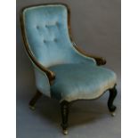 A VICTORIAN WALNUT FRAMED NURSING CHAIR having a padded buttoned back, low scrolled arms and