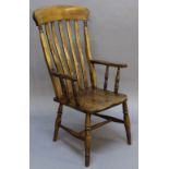 A 19TH CENTURY LATH-BACK ARMCHAIR with shaped crest-rail and vertical lath splats, open arms and