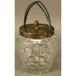 A GEORGE V SILVER-MOUNTED CUT-GLASS BISCUIT BARREL with arched swing handle and plain finial