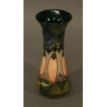 A MOORCROFT POTTERY 'CLUNY' PATTERN VASE of small proportions, tube-lined with stylised trees,