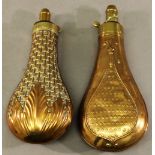 TWO 19TH CENTURY COPPER AND BRASS POWDER FLASKS of traditional form with brass nozzles and