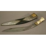 A BONE-HANDLED NEPALESE KUKRI, the bone handle signed, the leather scabbard with embossed white