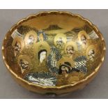 A SMALL JAPANESE SATSUMA BOWL of dished circular form with lobed rim, decorated with various figures