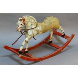 AN EARLY 20TH CENTURY BOW ROCKING HORSE of small proportions, constructed from pine with straw-