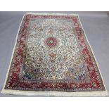 A TURKISH WOOL RUG with central foliate medallion in a floret filled ground and ornate spandrels, in