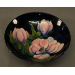 A MOORCROFT POTTERY 'MAGNOLIA' PATTERN BOWL of dished circular form, tube-lined with flowers against