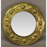 A KESWICK SCHOOL OF INDUSTRIAL ART (KSIA) BRASS FRAMED MIRROR, circular, the bevelled mirror plate