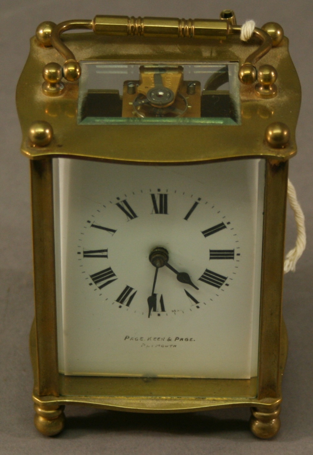 A FRENCH BRASS FIVE-GLASS CARRIAGE CLOCK of bowed form with shaped swing carrying handle, the
