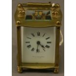 A FRENCH BRASS FIVE-GLASS CARRIAGE CLOCK of bowed form with shaped swing carrying handle, the