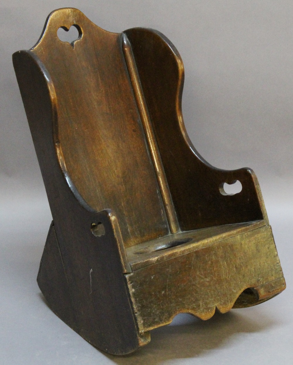 A 19TH CENTURY CHILD'S ROCKING CHAIR in the form of a lambing chair with commode aperture to the