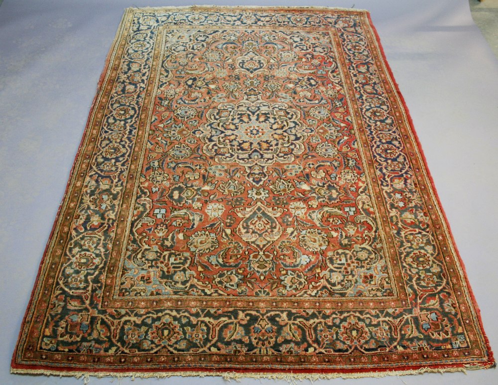 AN EASTERN RUG with central pole medallion and floret filled ground within borders, possibly