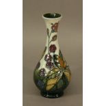 A SMALL MOORCROFT POTTERY 'BRAMBLE' PATTERN VASE of baluster form, tube-lined with fruit and
